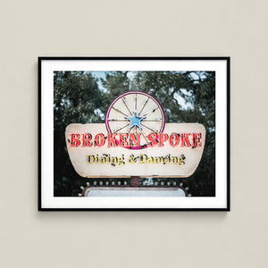 a sign for a restaurant called "Broken Spoke", which appears to be a dining and dancing establishment.