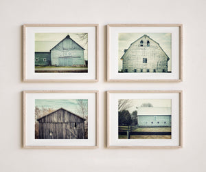 Top Left: Faded green barn with stone foundation and double doors, rustic countryside wall art.

Top Right: Vintage white barn with twin windows and aged siding, farmhouse-inspired wall art.

Bottom Left: Weathered wood barn with broken slats, surrounded by fall trees, rustic wall decor.

Bottom Right: Soft green barn behind a fence on an overcast day, classic farmhouse barn wall art.
