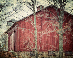 A set of six framed pictures depicting rural landscapes, including barns, fields, and trees, arranged in a grid on a wall.