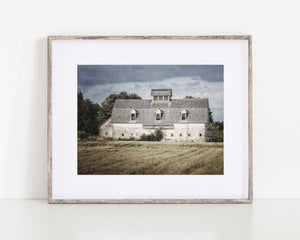 The image is a set of six framed pictures depicting various farm buildings, including barns and silos, arranged in a grid on a wall.
