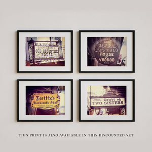 This image shows a set of four framed black and white photographs depicting various storefronts and signs, including "Jean Absinthe House" and "Famous Two Sisters Court of Voodoo".